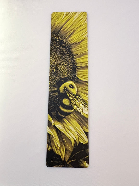 Bookmark with a design of a bee on a sunflower against a white background